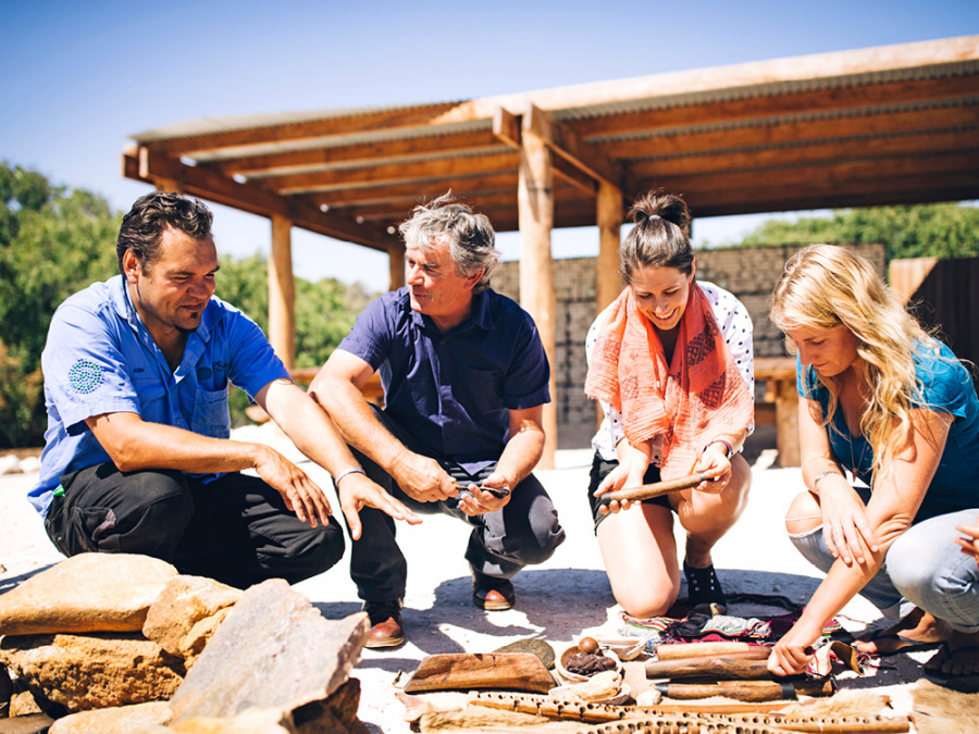 Tourists watching traditional Australian items on Koomal Dreaming Cultural Experience