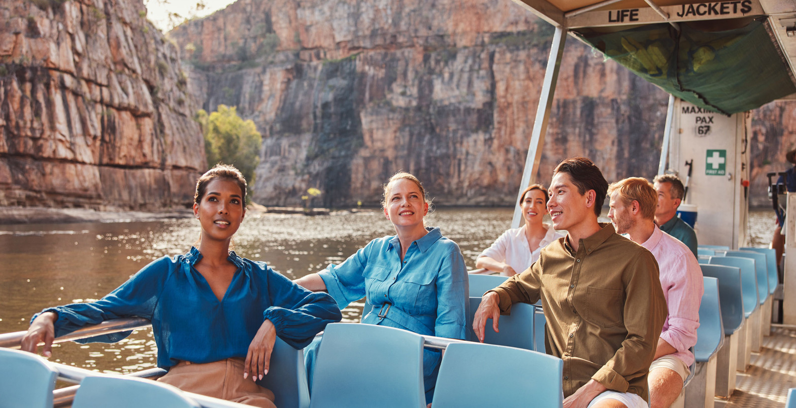 A group of people sitting on a boat in the water