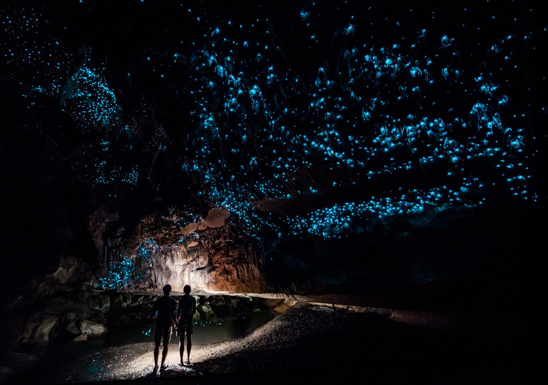 Couple Standing Underneath Glow Worm Sky In Waipu Cave, New Zealand 912291130
