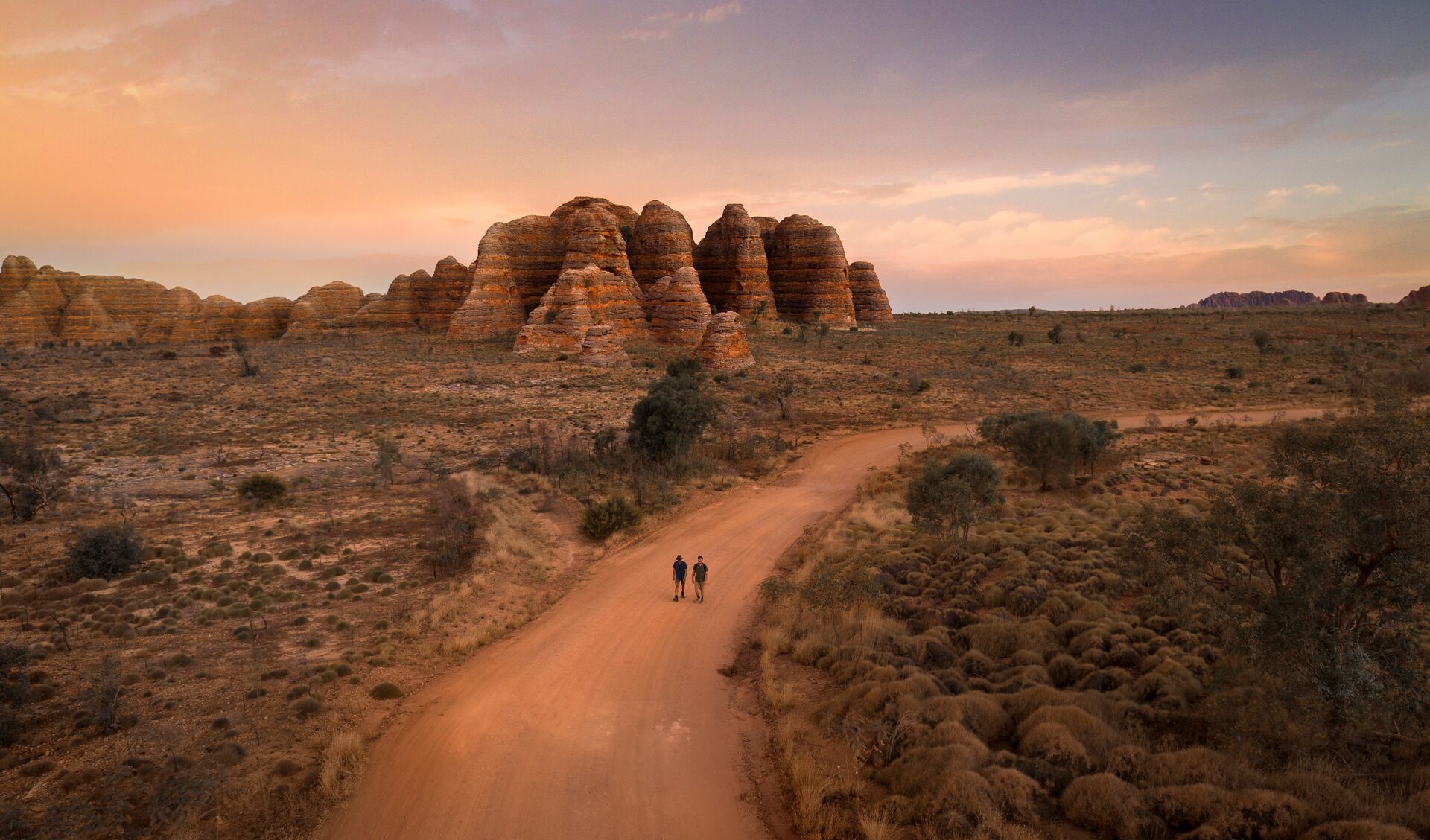 Two people walking down Bungle Bungle Range