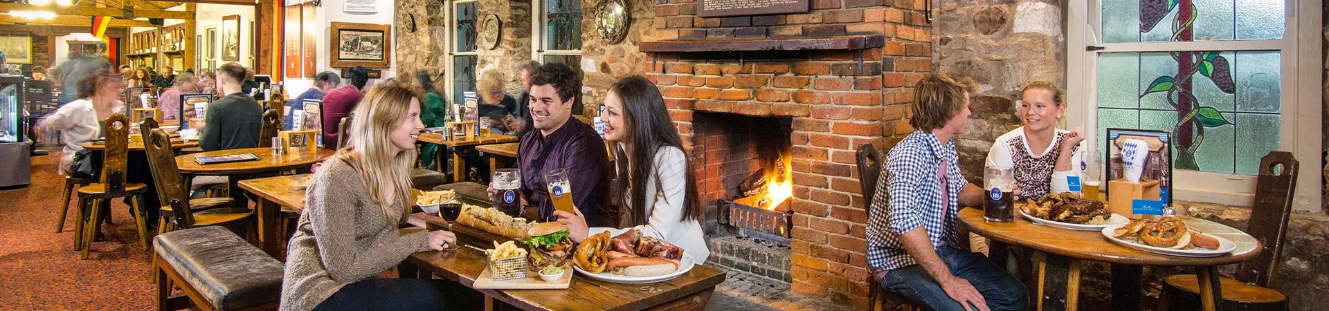 People eating and drinking beer in a restaurant in Hahndorf
