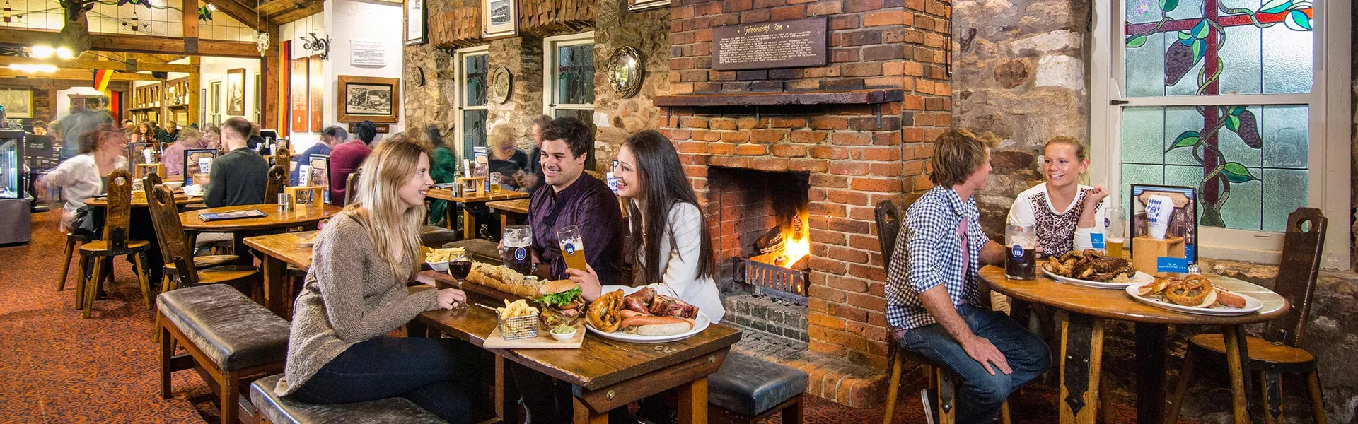 People eating and drinking beer in a restaurant in Hahndorf