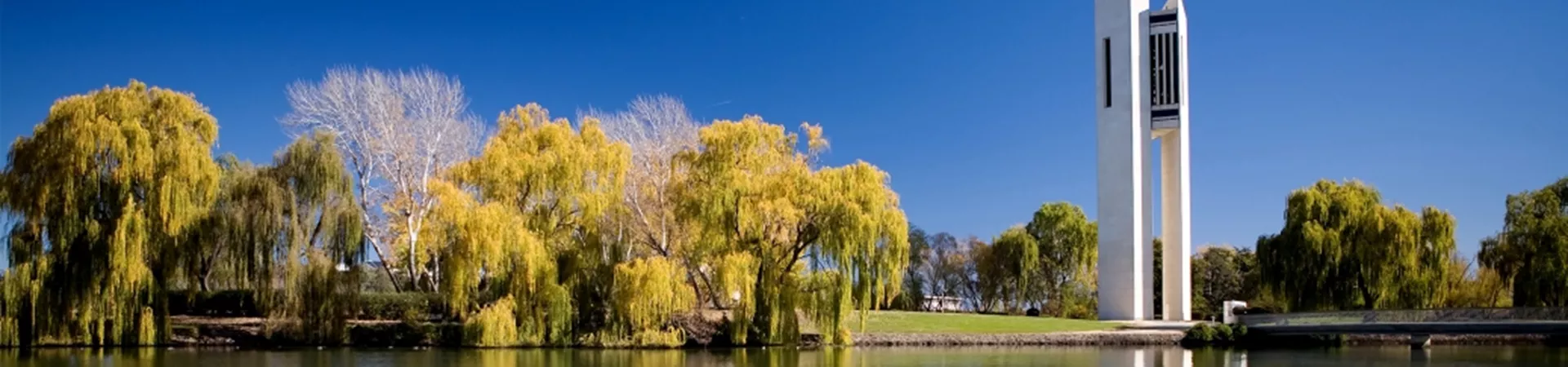 A tall tower sitting next to a body of water