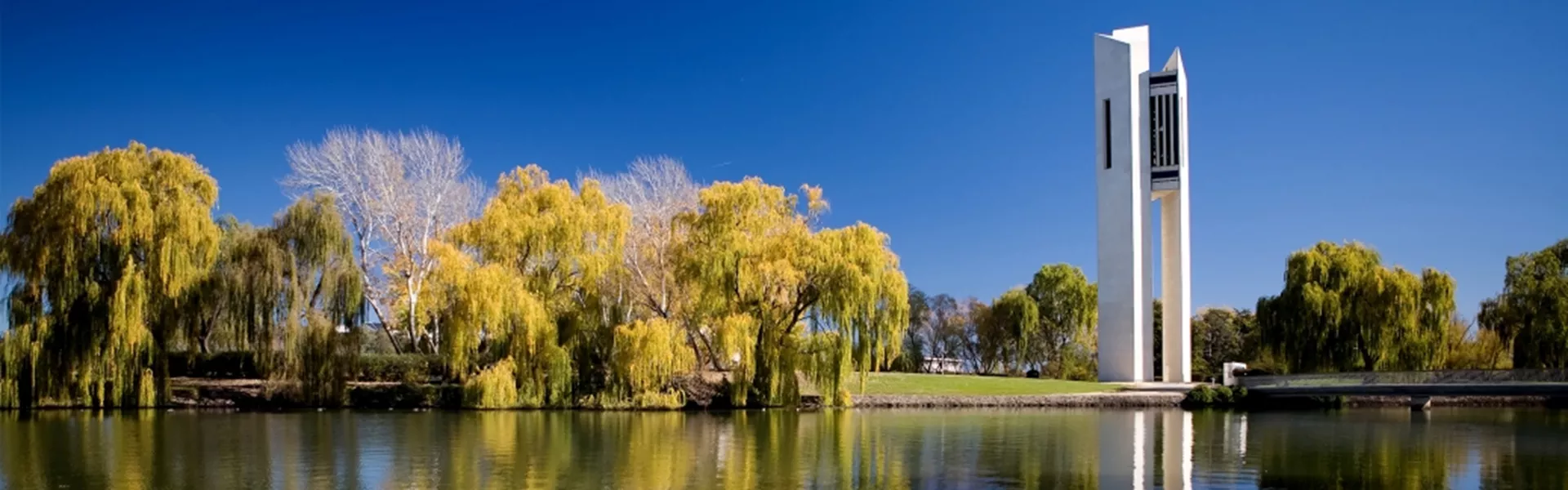A tall tower sitting next to a body of water