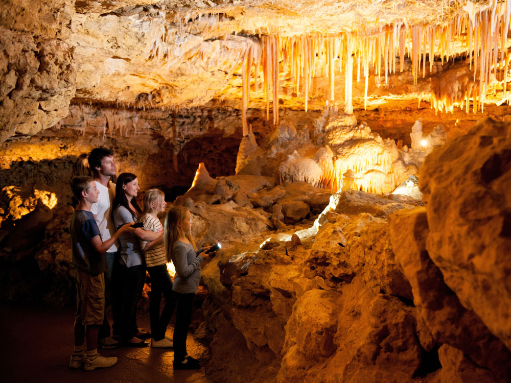 A group of people standing in a cave