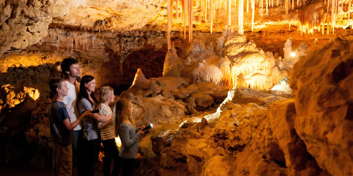 A group of people standing in a cave