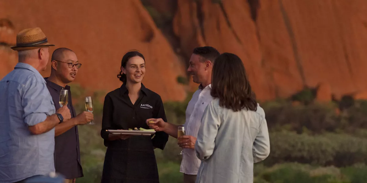 A group of people standing next to each other with glasses