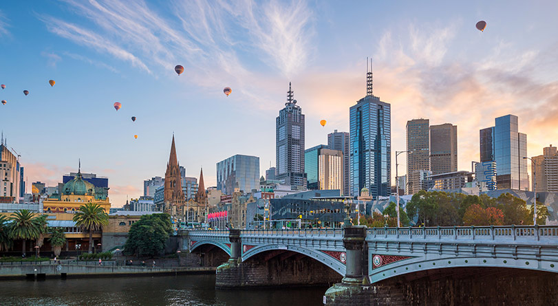 View on Melbourne with hot air balloons in the sky