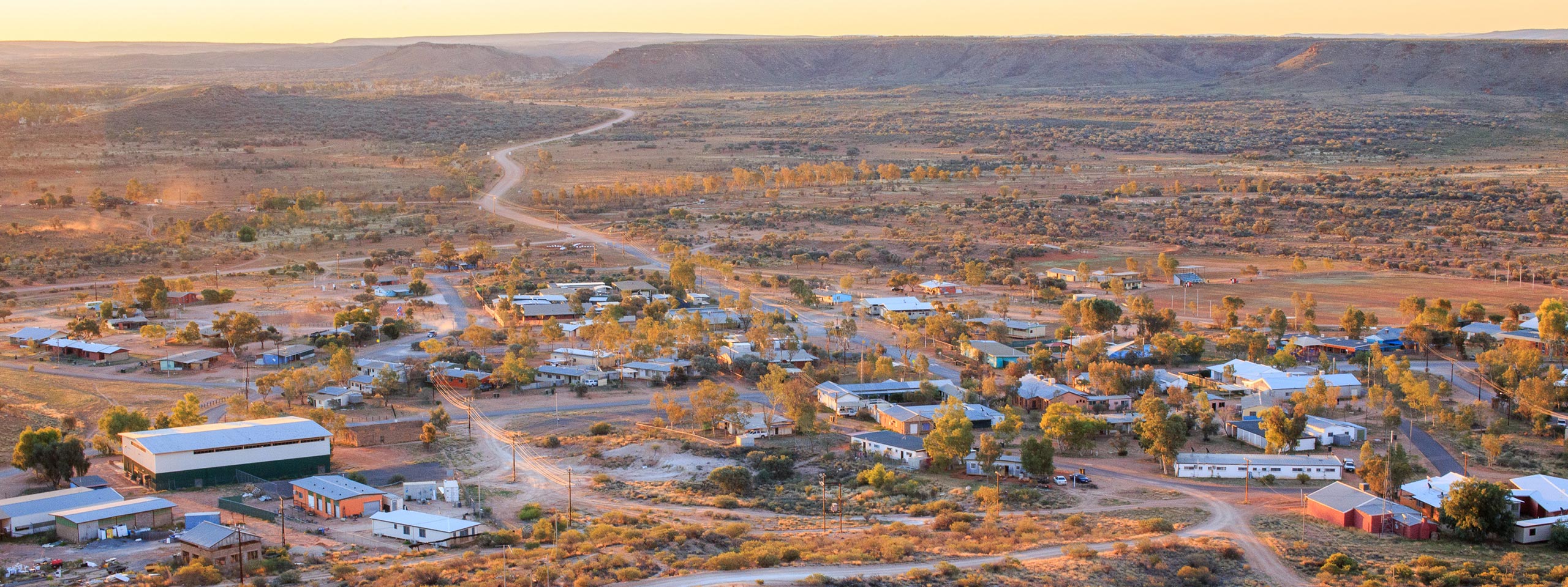 An aerial view of a small town surrounded by mountains