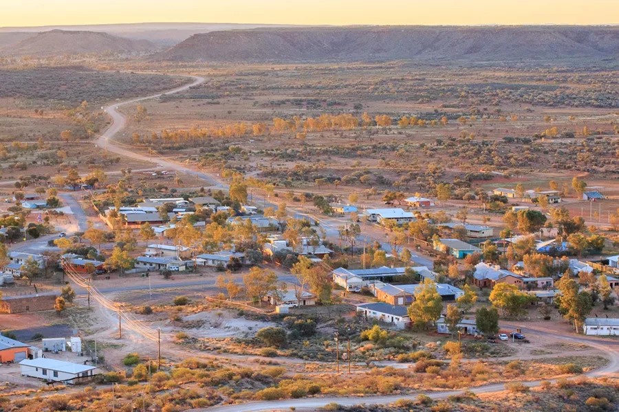 An aerial view of a small town surrounded by mountains