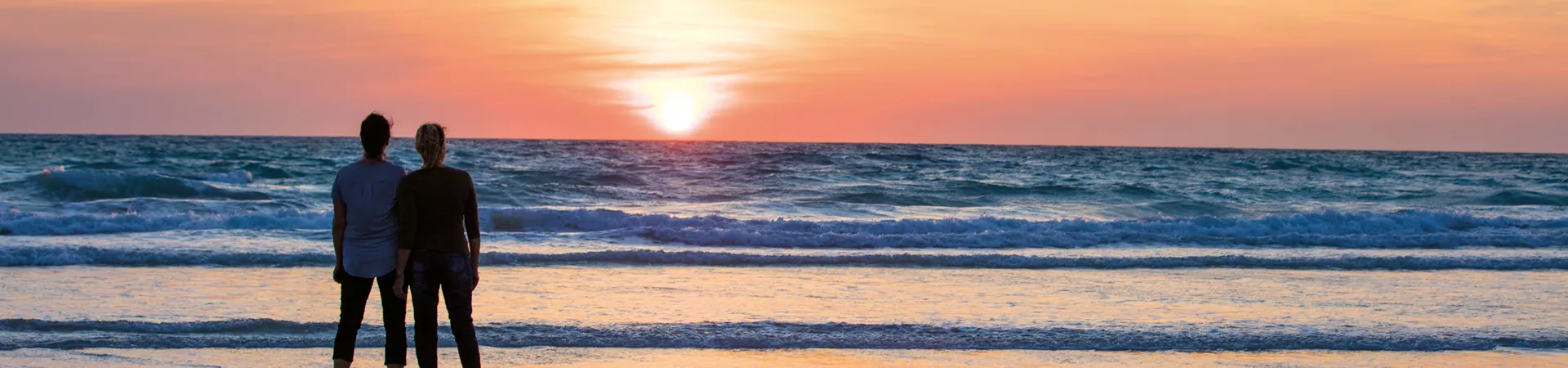 A couple admiring sunset at Cable Beach