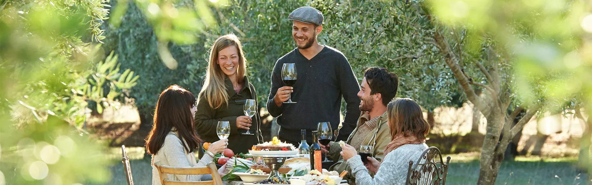 A group of people enjoying their lunch in a garden