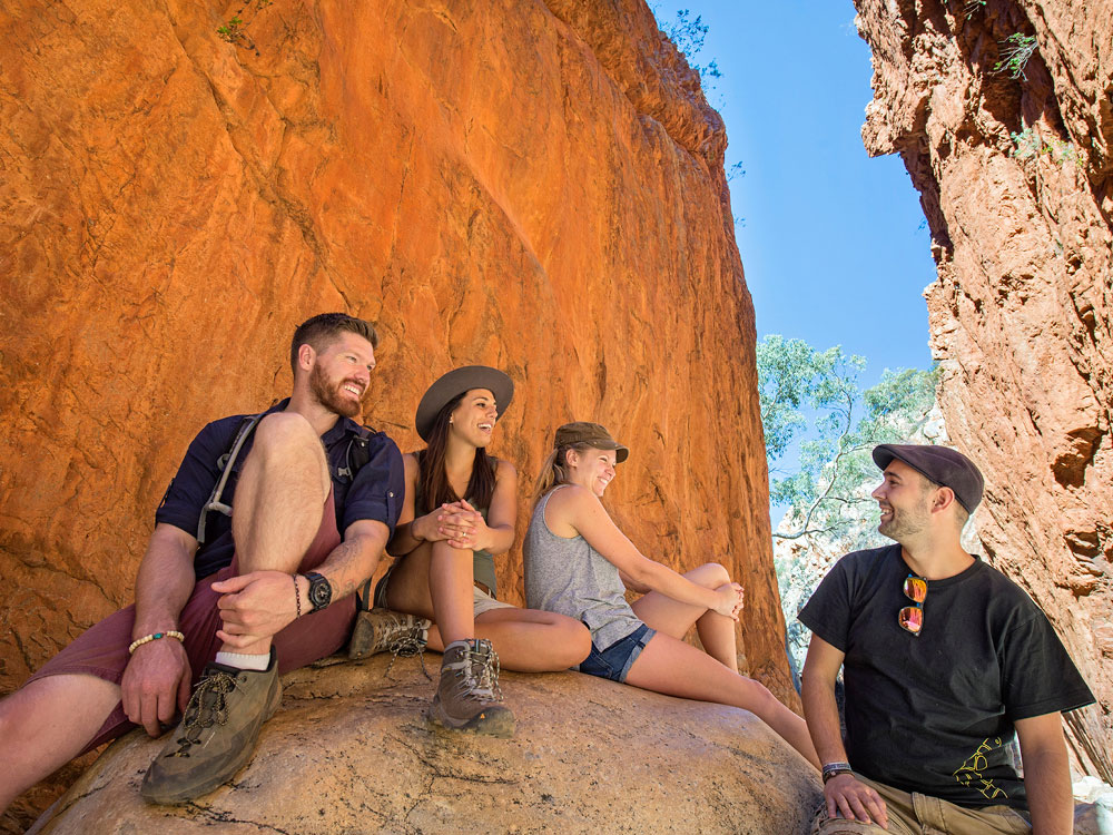 A group of people sitting on top of a rock
