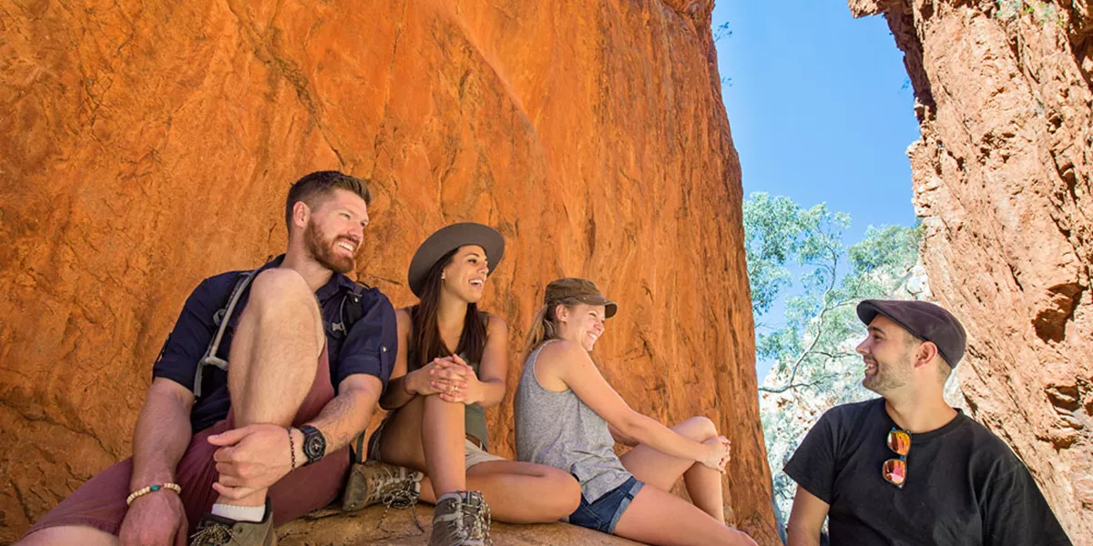 A group of people sitting on top of a rock