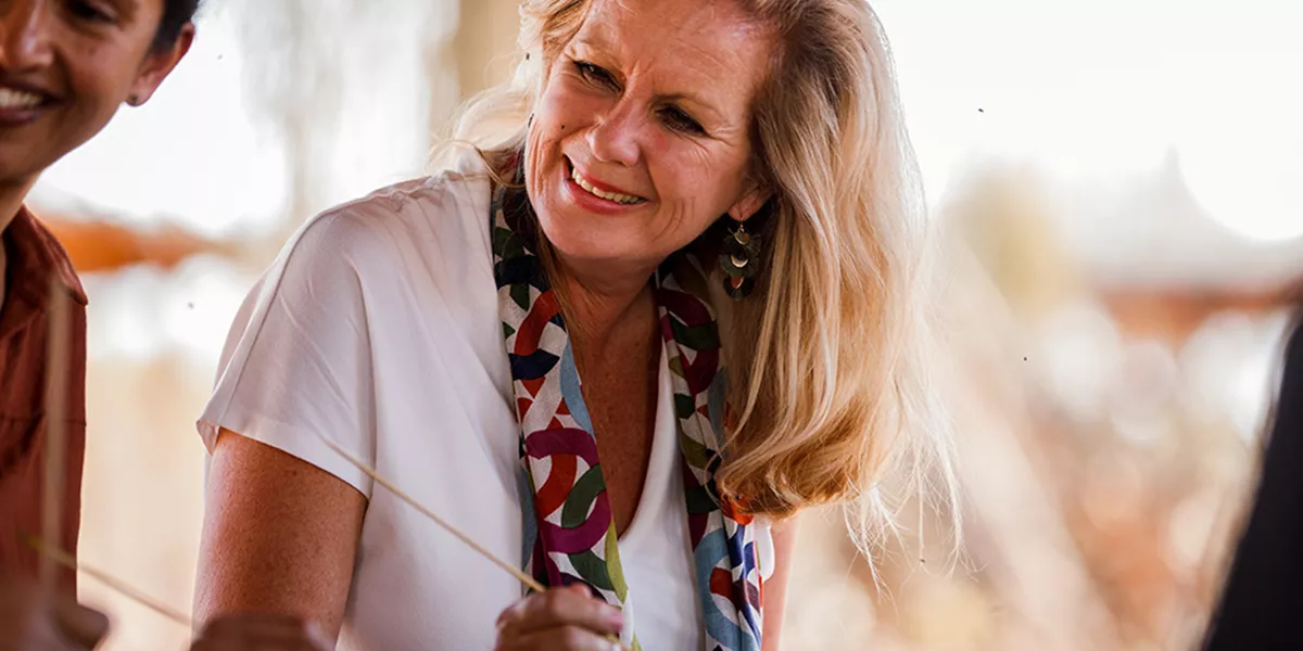 An older woman sitting at a table next to a man