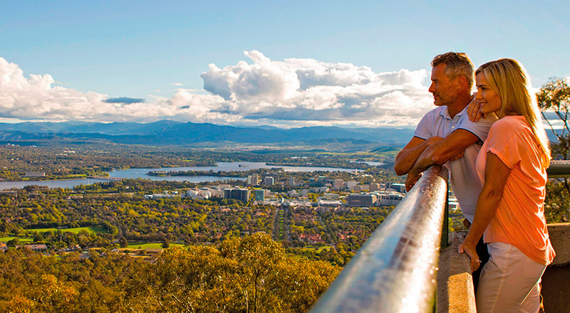Couple looking at the landscape of Mount Ainslie on sunny day