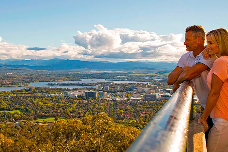 Couple looking at the landscape of Mount Ainslie on sunny day
