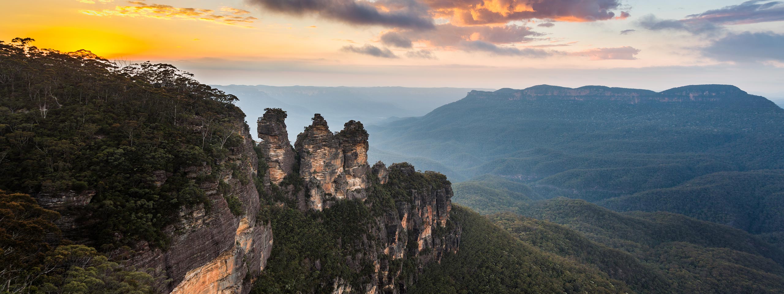 The Three Sisters rock formation by sunset