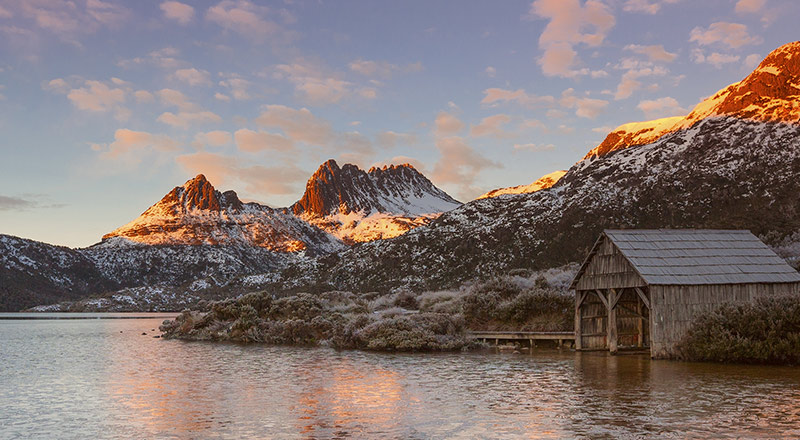 View on sunset over Cradle Mountain with lake and wooden building