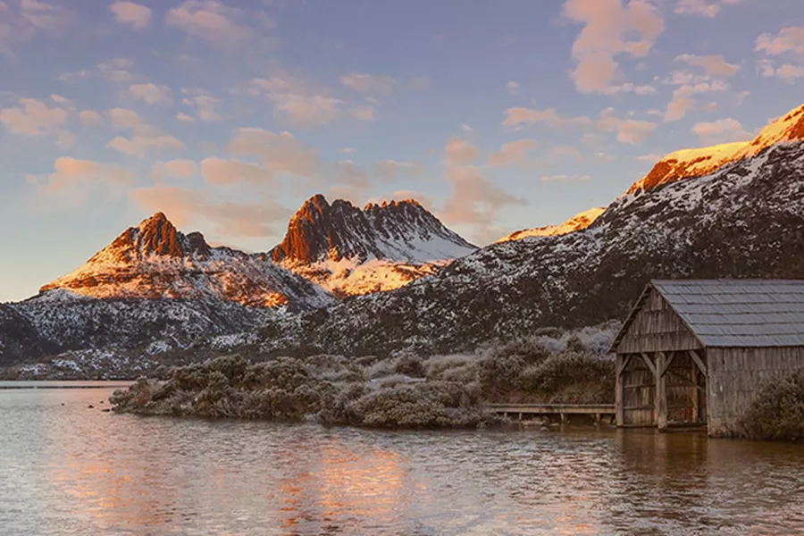 View on sunset over Cradle Mountain with lake and wooden building