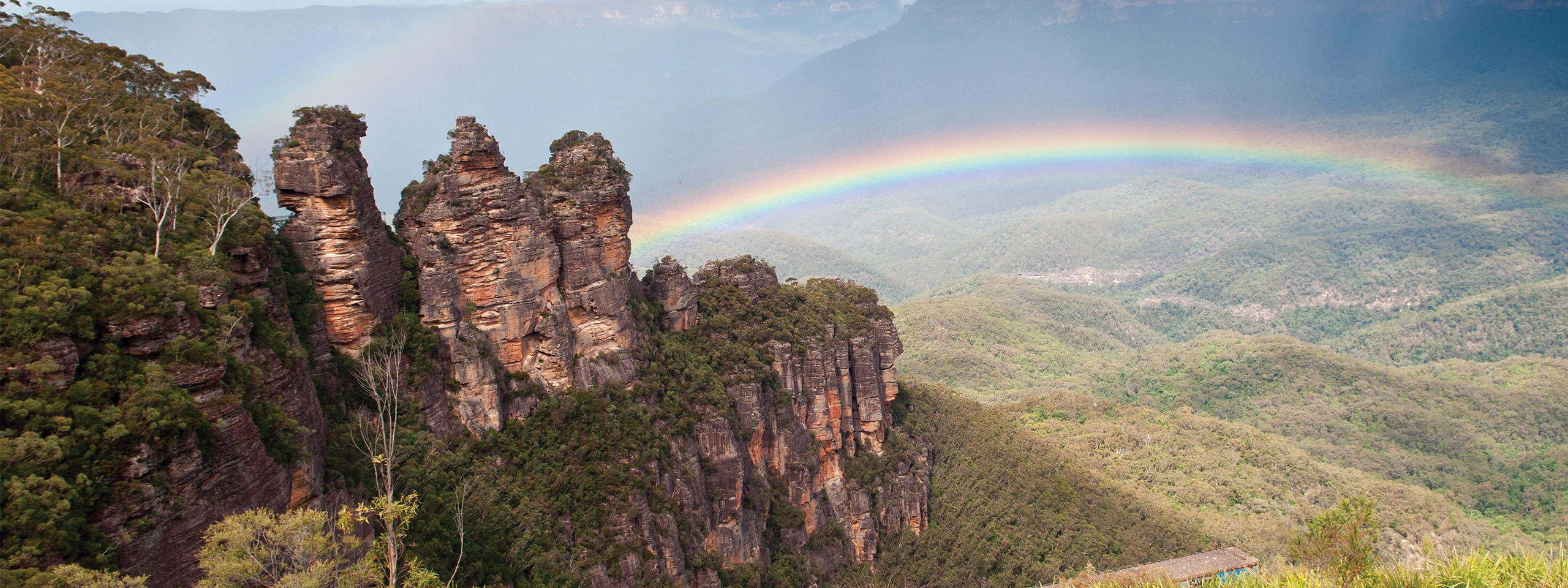 Three Sisters in Blue Mountains with rainbow in the background