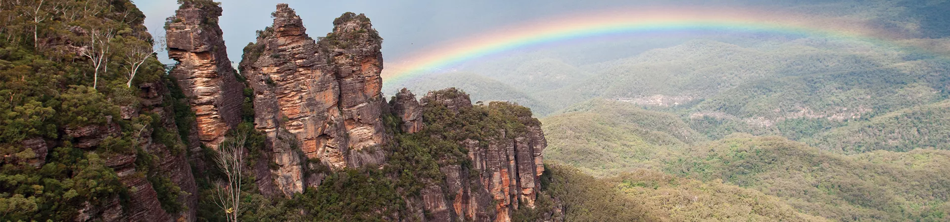 Three Sisters in Blue Mountains with rainbow in the background