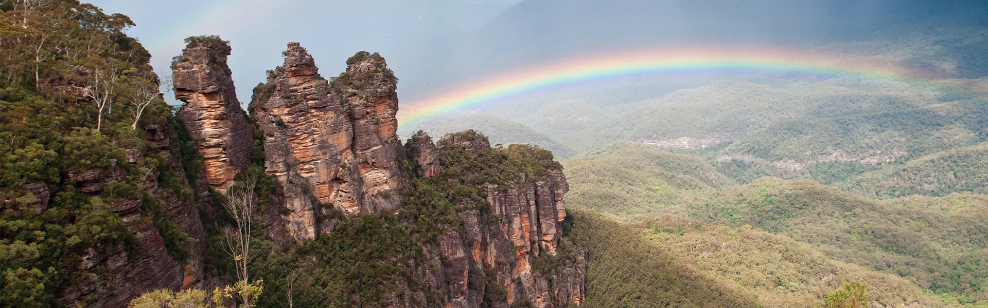 Three Sisters in Blue Mountains with rainbow in the background