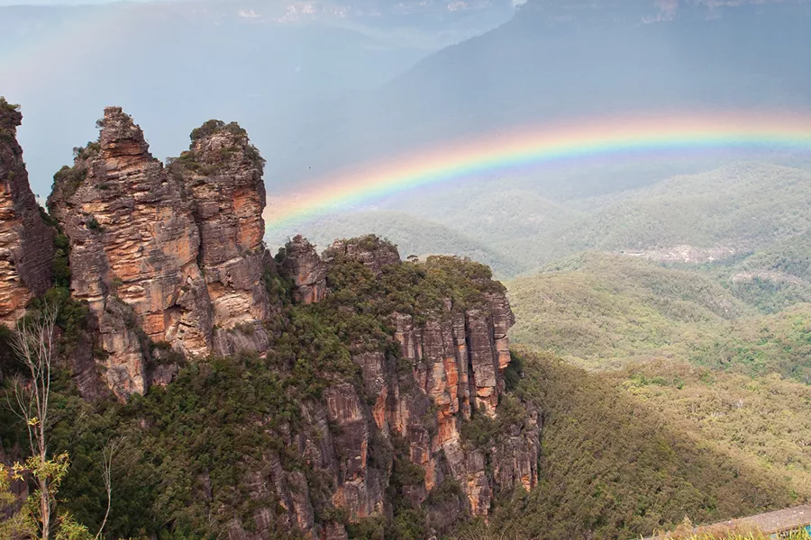 Three Sisters in Blue Mountains with rainbow in the background