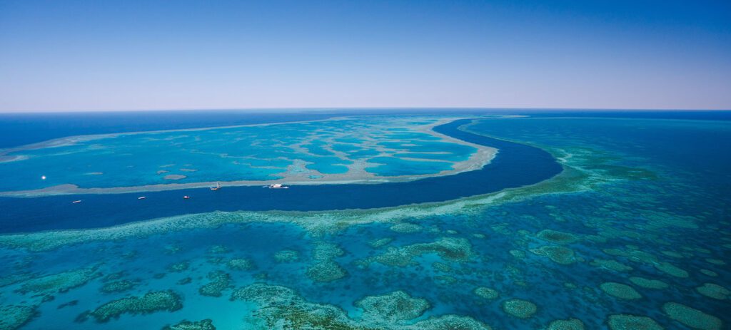 A high-altitude view of the reef’s vivid blue coral formations.