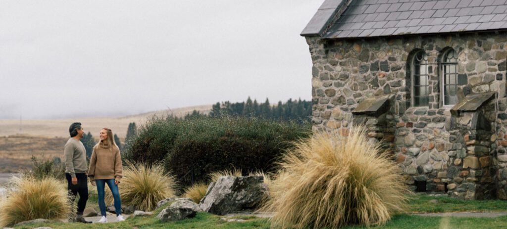 The Church of the Good Shepherd overlooking Lake Tekapo, with alpine grasses and distant mountains in New Zealand.