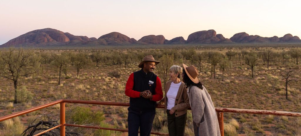 Travellers with guide overlooking Kata Tjuta rock formations in the Northern Territory