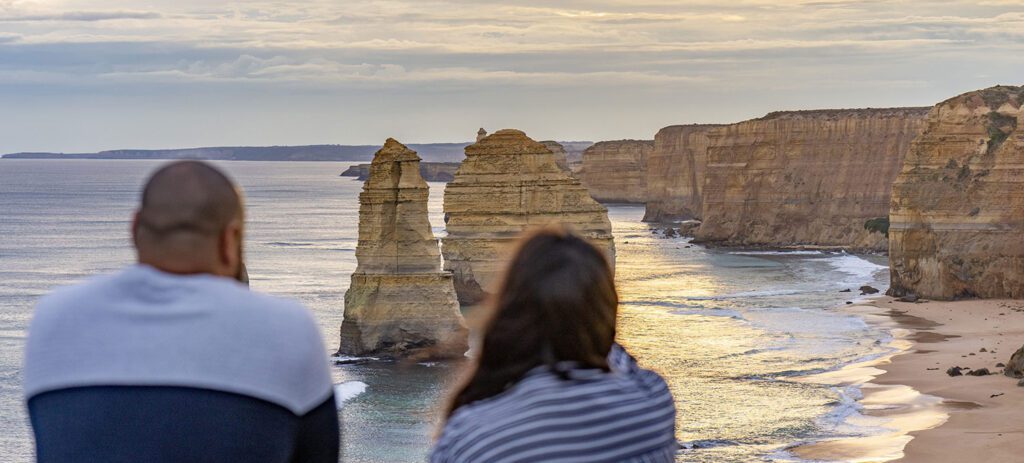 Two people viewing coastal rock formations