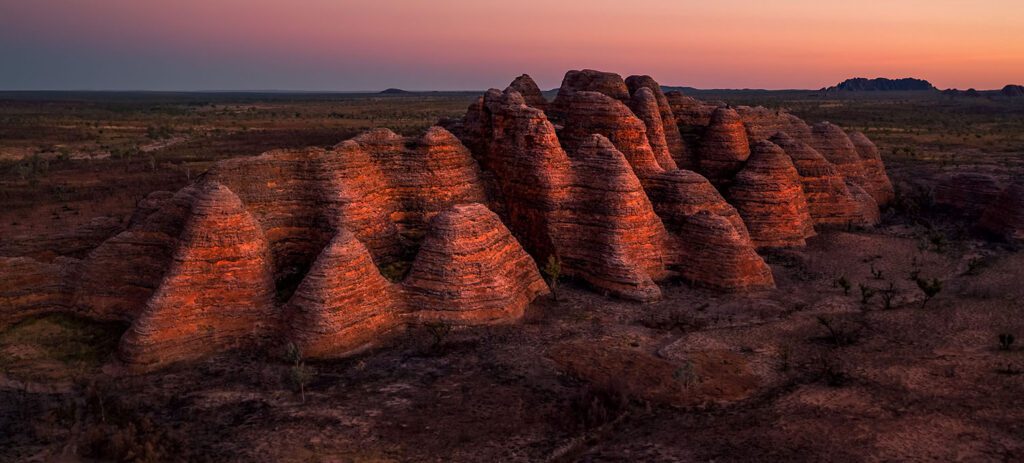 Striped sandstone domes at sunset