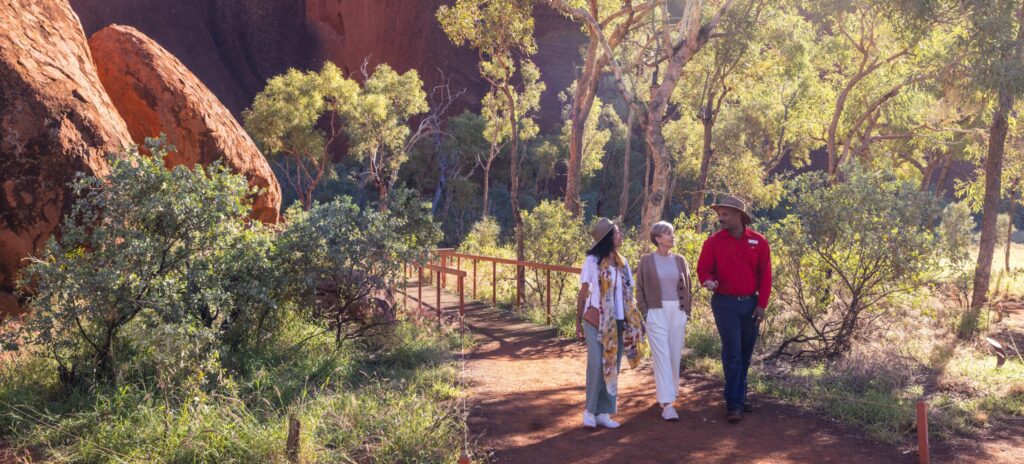 Visitors at the base walk of Uluru with an AAT Kings Guide