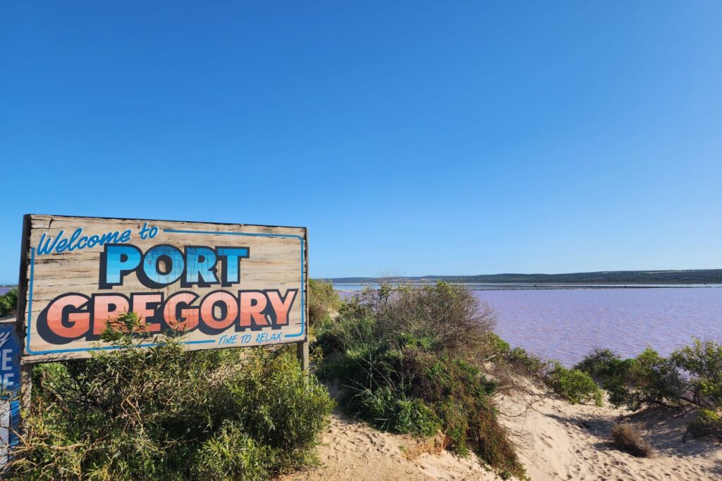 A rustic sign saying Port Gregory looking out over a bay